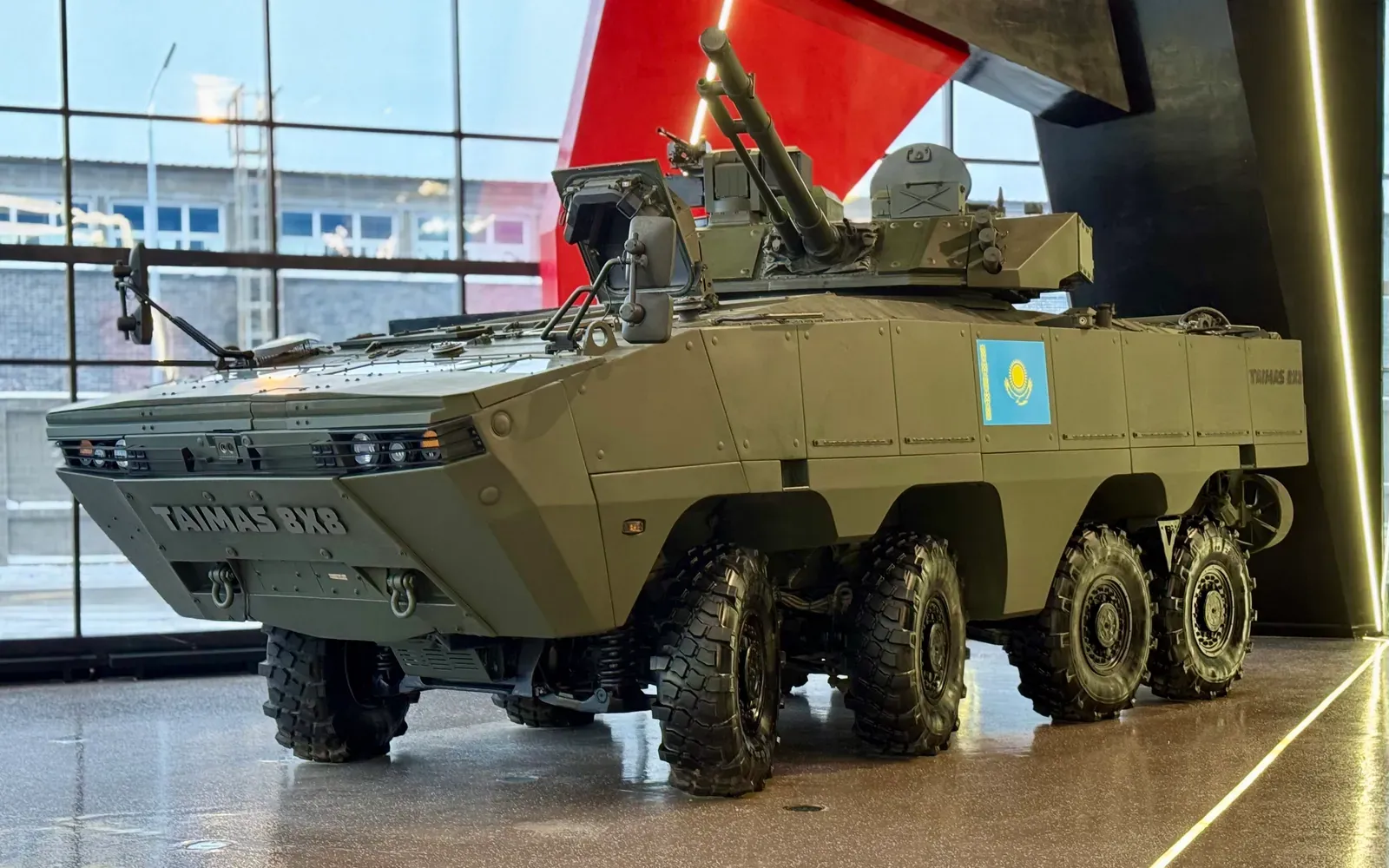 TAIMAS 8×8 on display with the flag of Kazakhstan