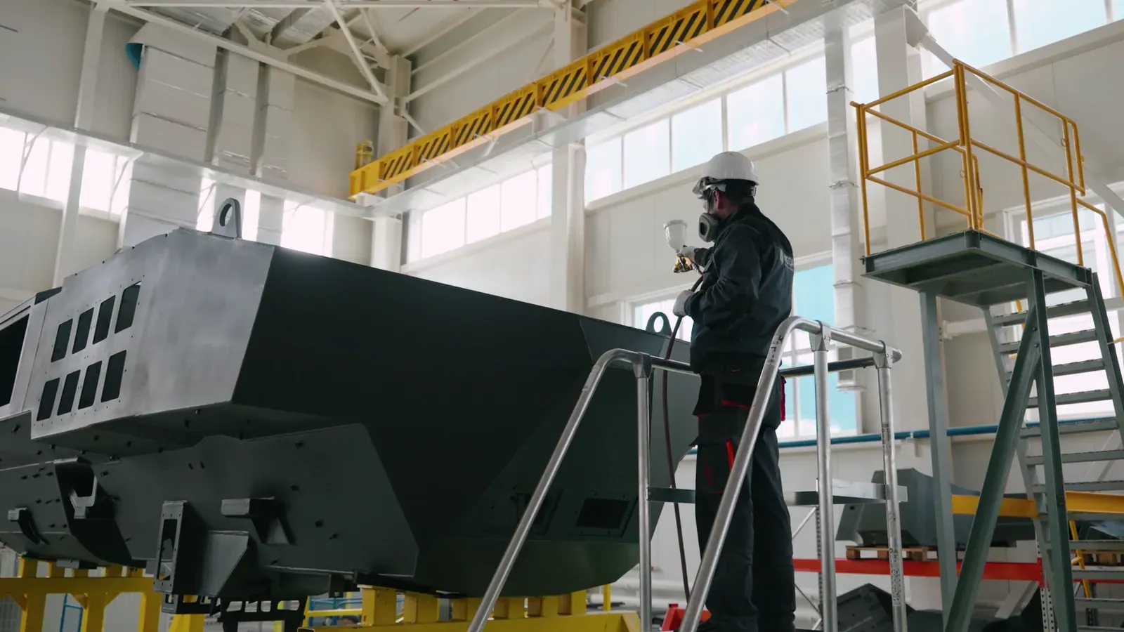 Painter at work on an armoured hull