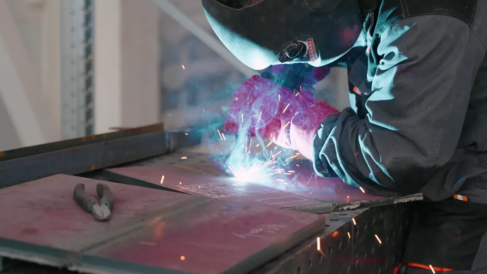 Welder joining armour plates